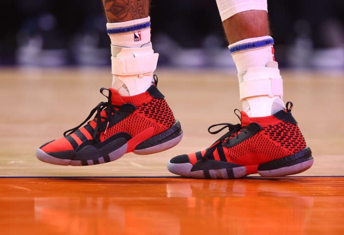 View of Trae Young's red and black adidas shoes.